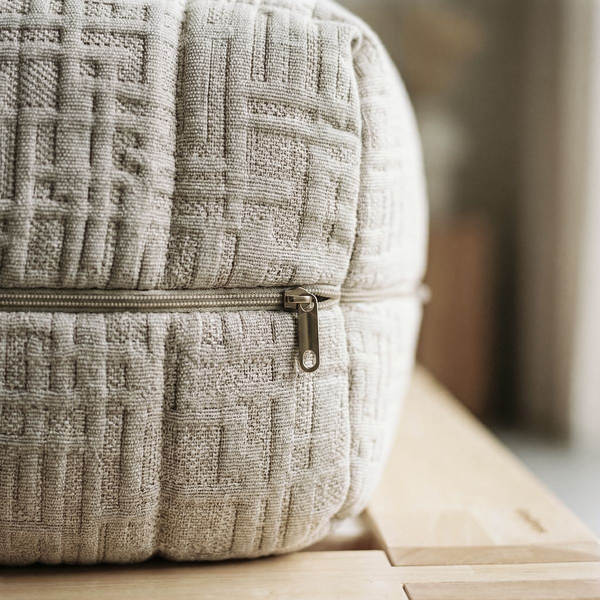 Close-up of a woven cover with a zip